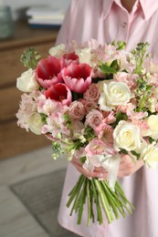 Photo of Woman with beautiful bouquet of fresh flowers indoors, closeup