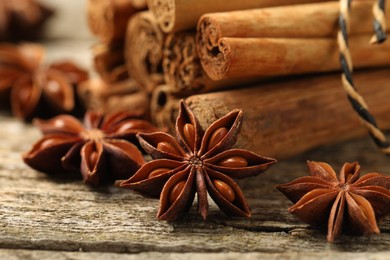 Cinnamon sticks and star anise on wooden table, closeup