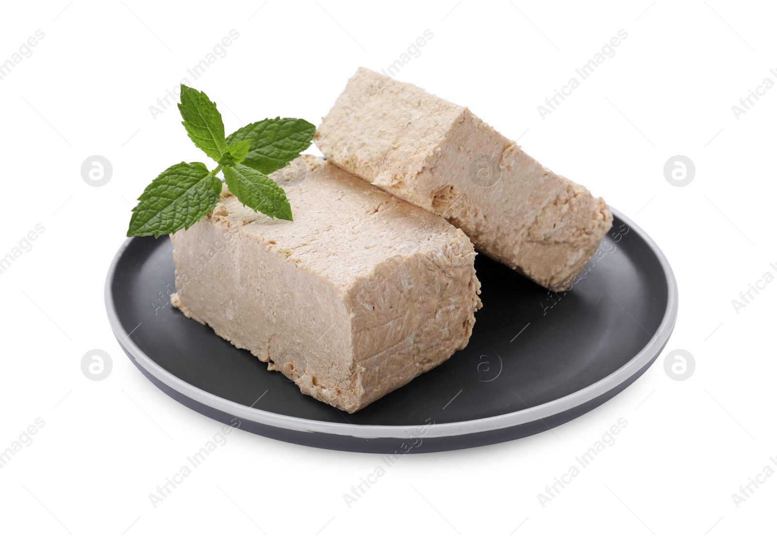Photo of Plate with pieces of tasty halva and mint isolated on white