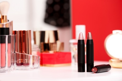 Photo of Different lipsticks on dressing table. Space for text