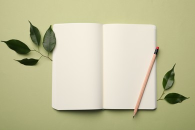 Photo of Open notebook, pencil and leaves on light green background, flat lay. Personal planning