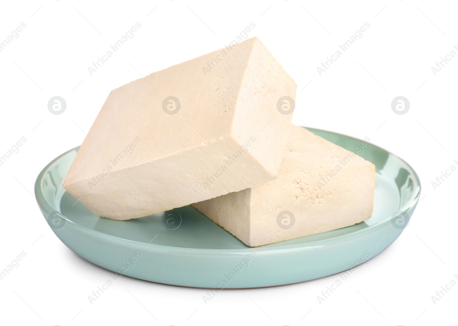 Photo of Plate with delicious raw tofu isolated on white