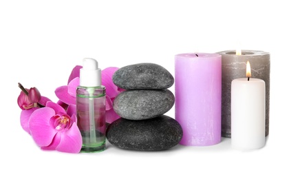 Composition with spa stones and candles on white background