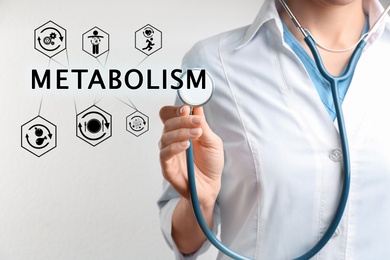 Image of Metabolism concept. Doctor with stethoscope on light background, closeup