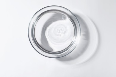 Photo of Glass bowl with water on white background, top view