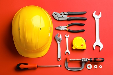 Photo of Flat lay composition with construction tools on color background