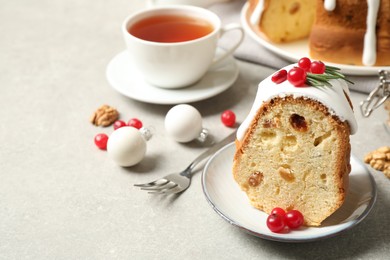 Photo of Composition with piece of traditional homemade Christmas cake on light grey table, closeup