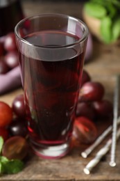 Photo of Delicious grape soda water on table, closeup. Refreshing drink