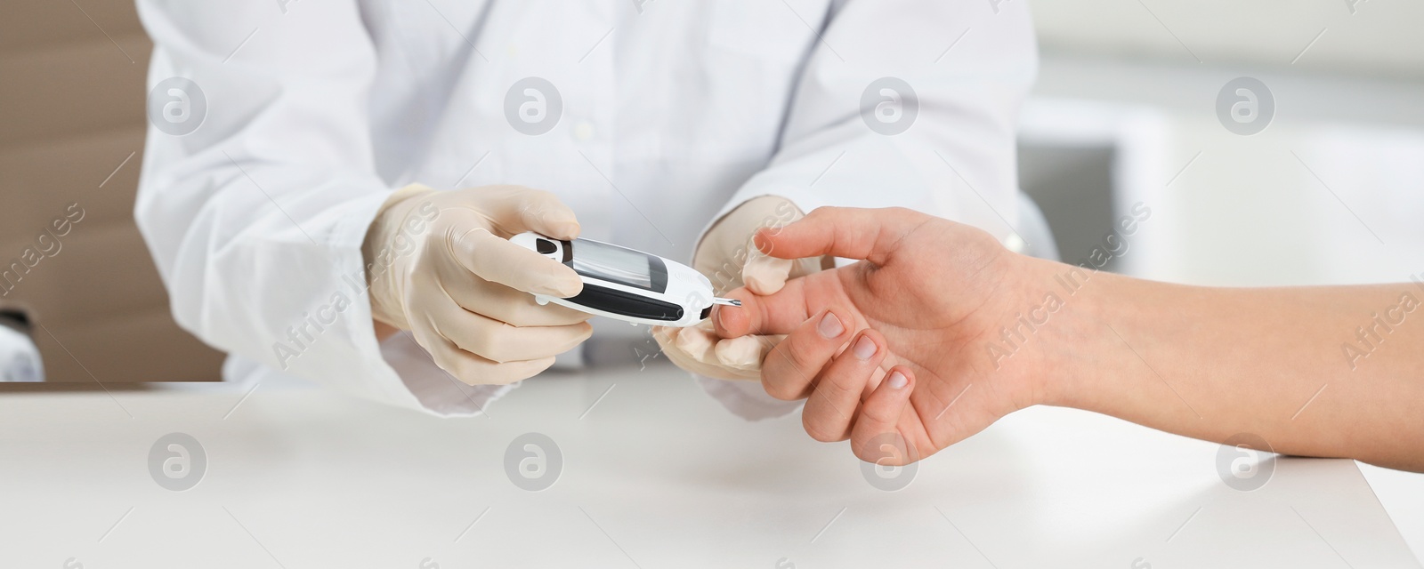 Image of Endocrinologist checking patient's blood sugar level with digital glucometer at table, closeup. Banner design