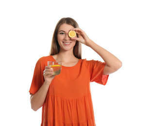 Photo of Young woman with glass of lemon water on white background