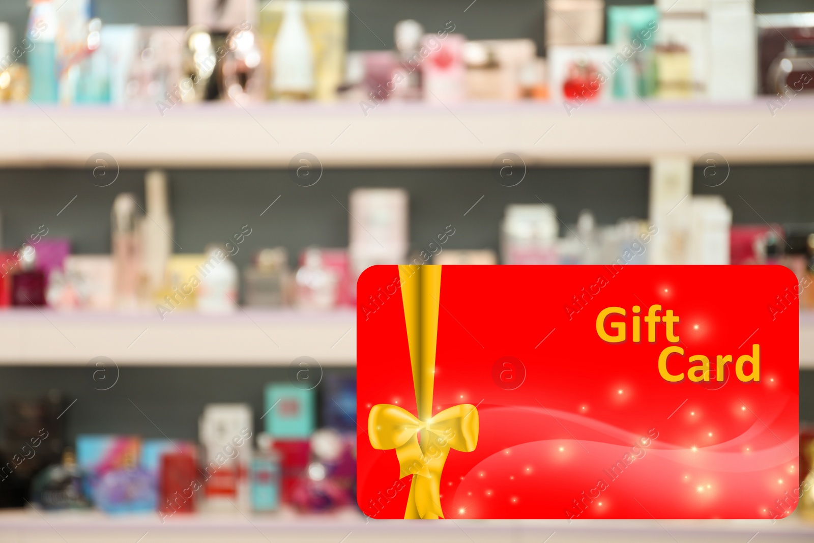 Image of Store gift card. Blurred view of shelves with perfume bottles in shop