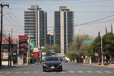 San Pedro Garza Garcia, Mexico – March 20, 2023: Beautiful view of city street with road, cars and buildings