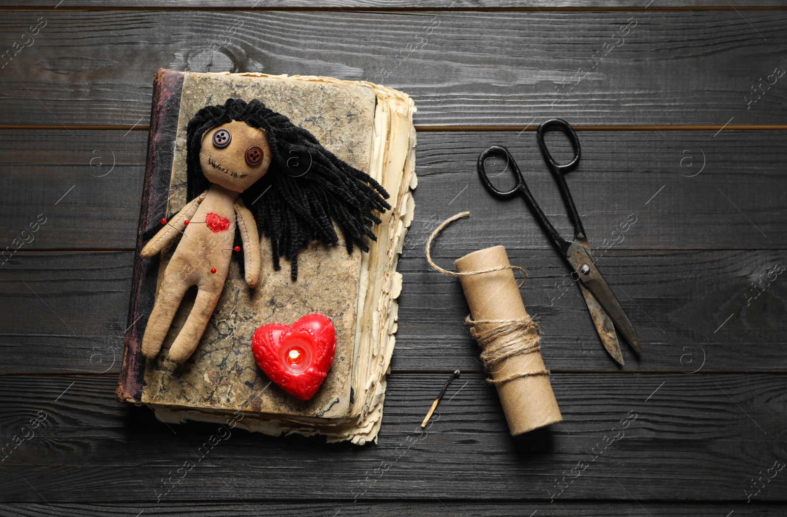 Photo of Flat lay composition with voodoo doll on dark wooden table
