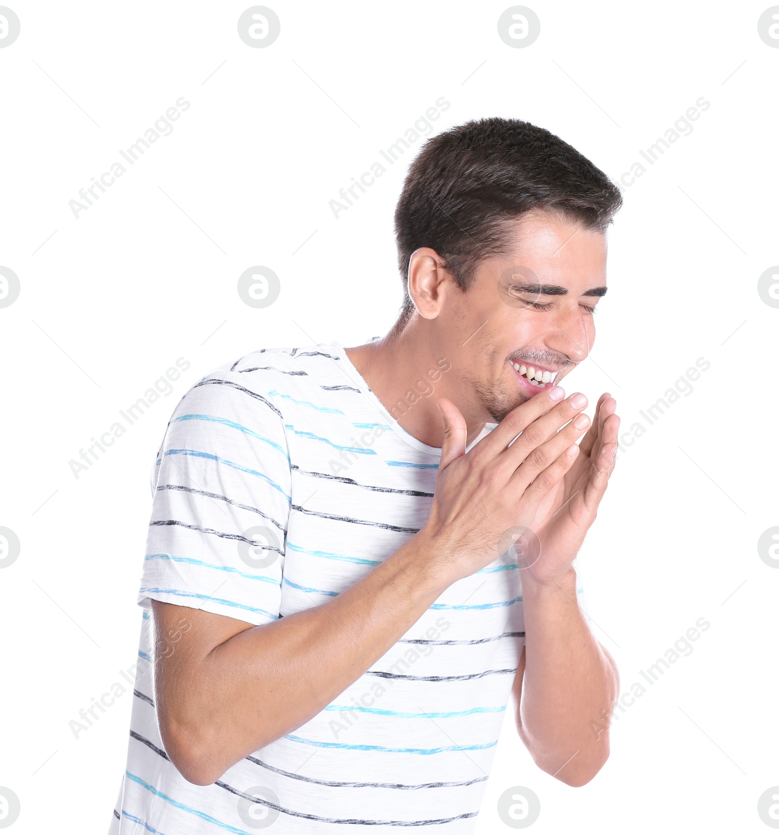 Photo of Portrait of handsome young man laughing on white background