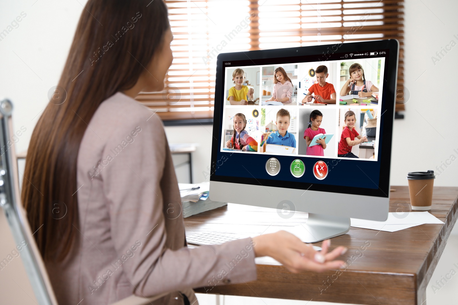 Image of Teacher giving online school lesson during quarantine and social distancing due to Covid-19 pandemic. Pupils studying at home via video conference