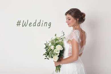 Image of Young bride with beautiful bouquet and hashtag Wedding on white background 