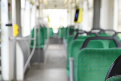 Photo of Blurred view of public transport interior with comfortable green seats