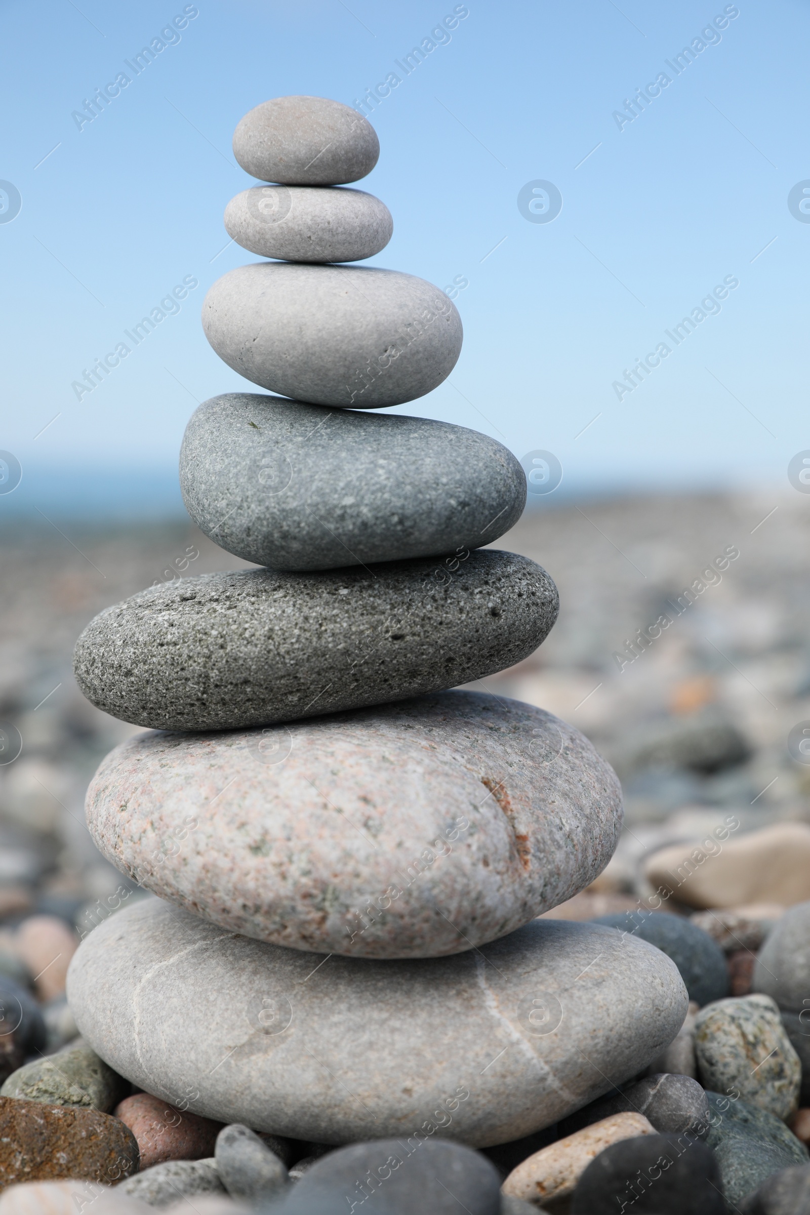 Photo of Stack of stones on beach against blurred background, closeup