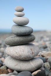 Stack of stones on beach against blurred background, closeup