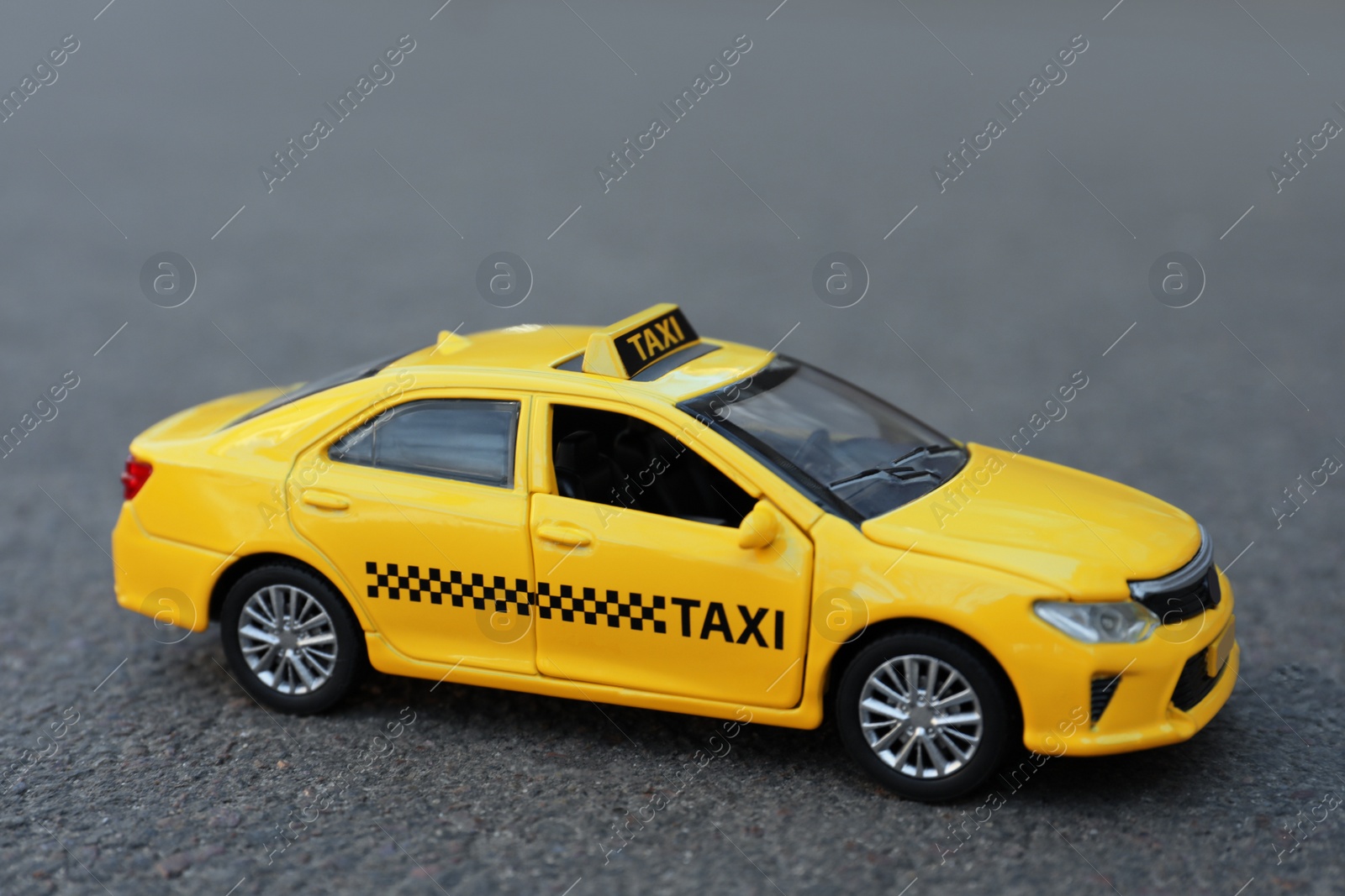 Photo of Yellow taxi car model on city street