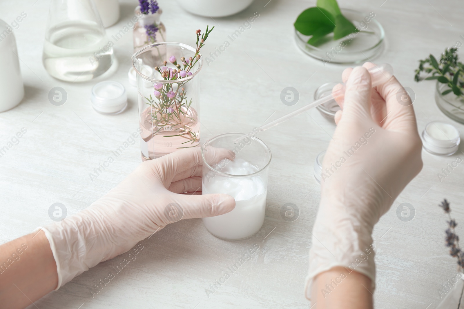 Photo of Scientist developing cosmetic product in laboratory, closeup