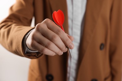 Photo of Businesswoman holding red dart on white background, closeup