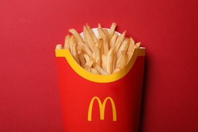 MYKOLAIV, UKRAINE - AUGUST 12, 2021: Big portion of McDonald's French fries on red background, top view