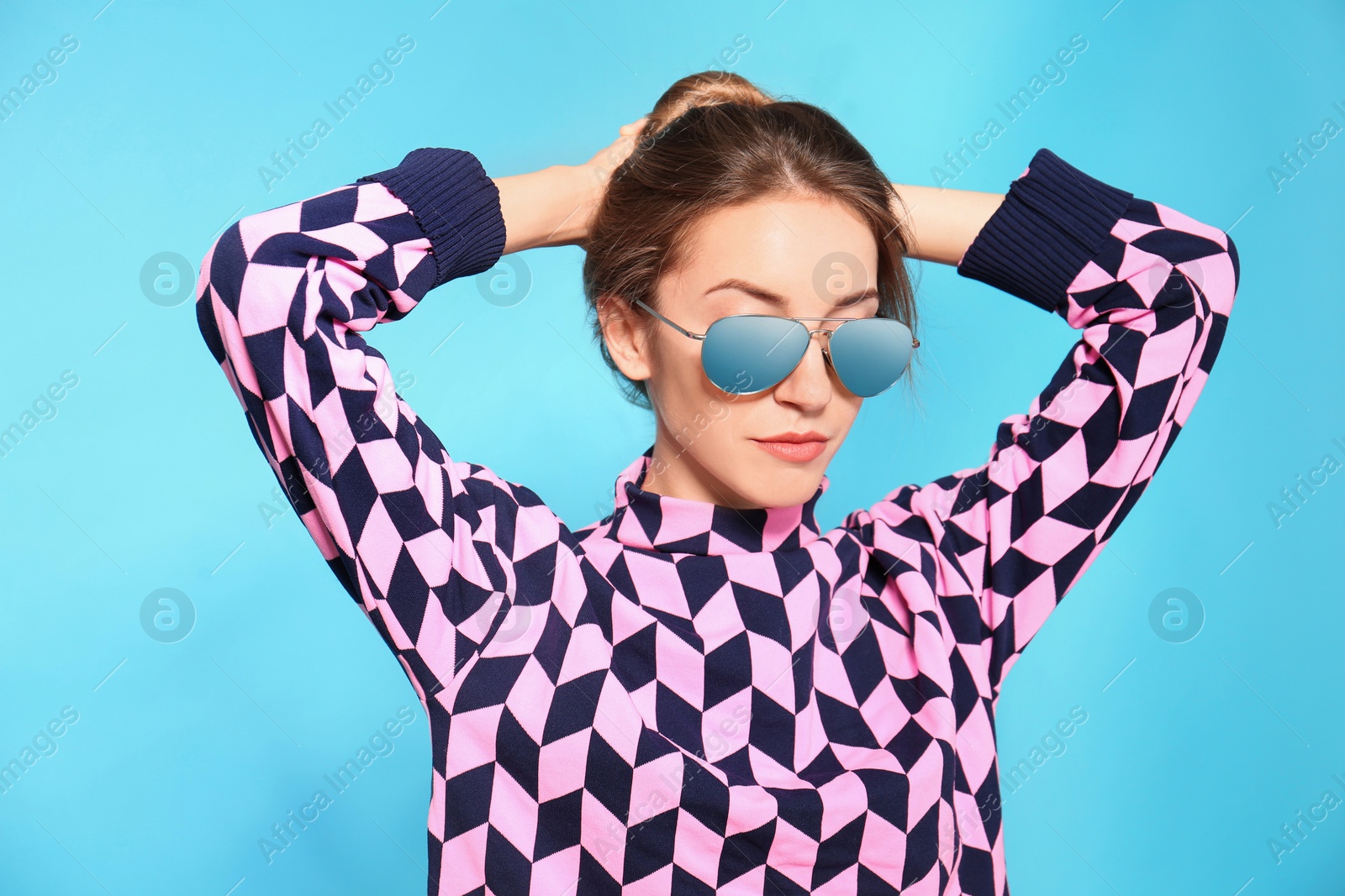 Photo of Young woman wearing stylish sunglasses on blue background