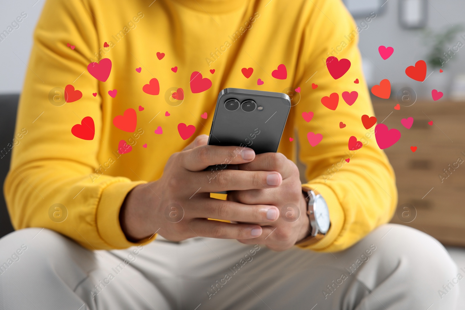 Image of Long distance love. Man sending or receiving text message, closeup. Hearts flying out of device