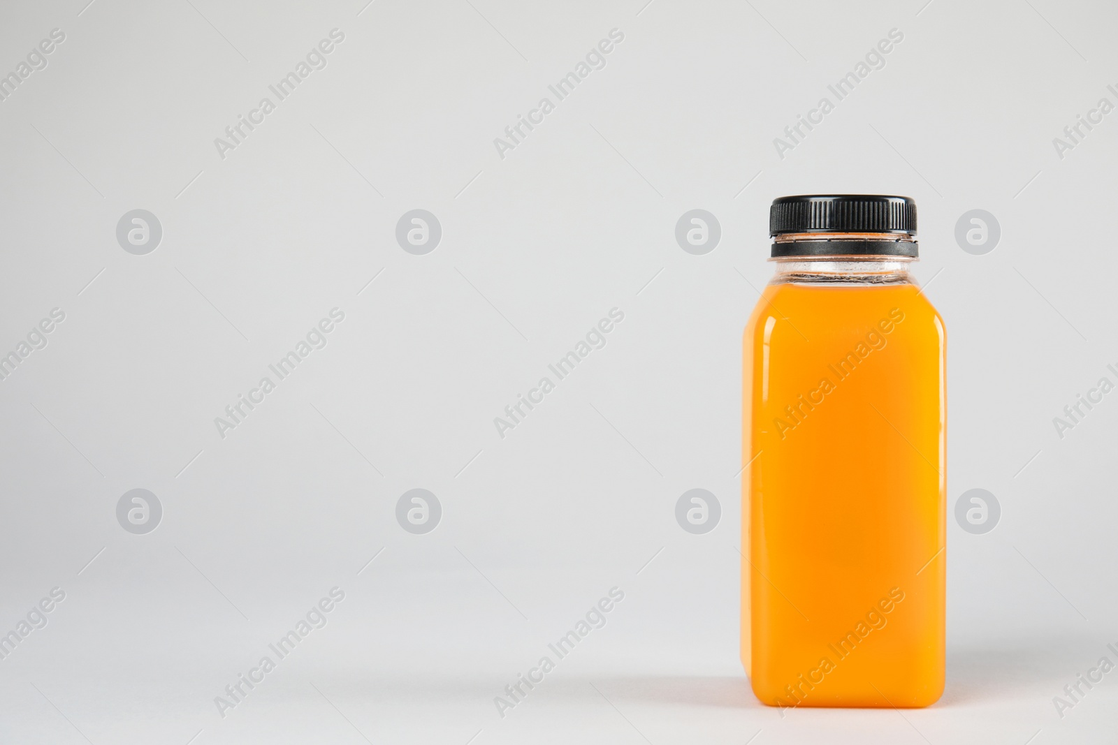 Photo of One bottle with tasty drink on color background. Space for text