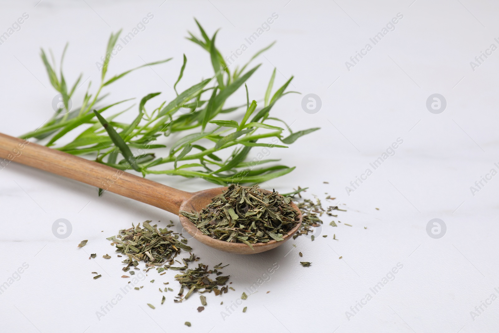Photo of Dry and fresh tarragon on white table, space for text