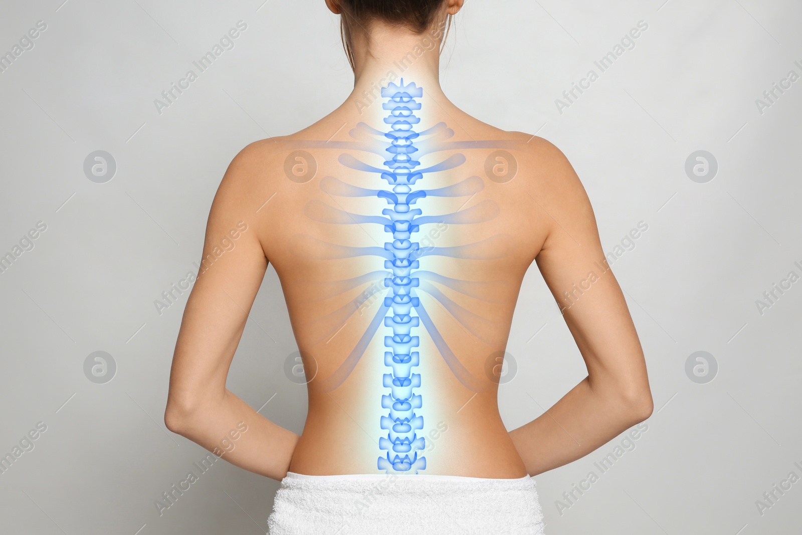 Image of Woman with healthy spine on light background, back view