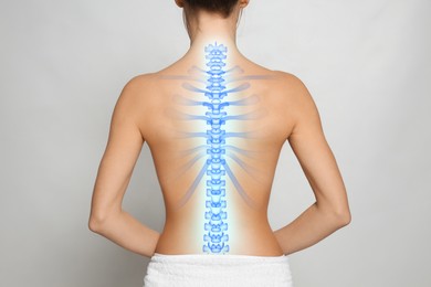 Image of Woman with healthy spine on light background, back view