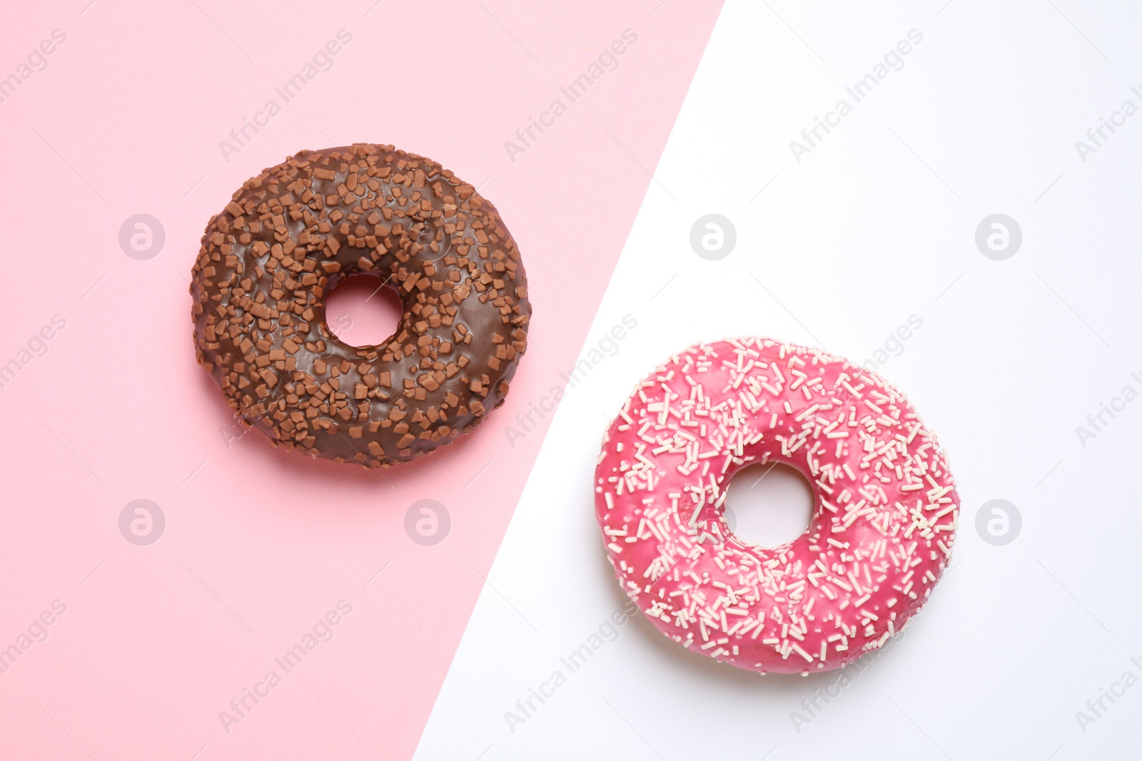 Photo of Delicious glazed donuts on color background, flat lay