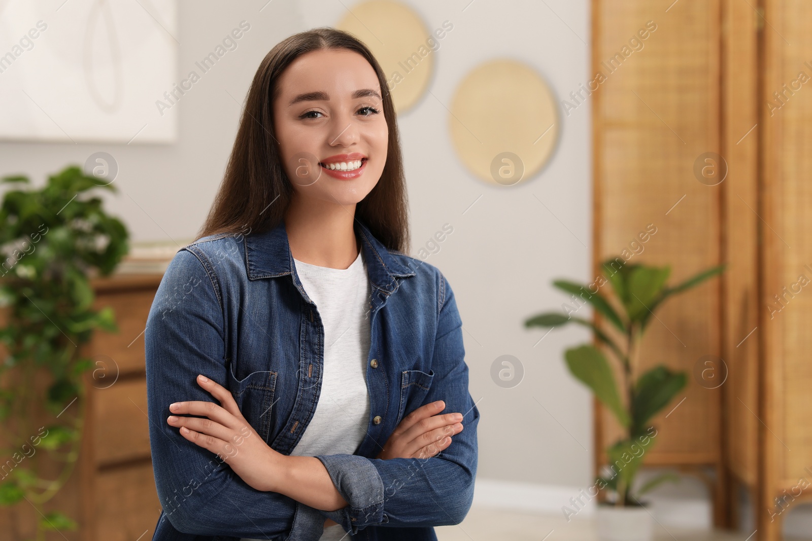 Photo of Portrait of beautiful young woman indoors, space for text. Attractive lady smiling and looking into camera