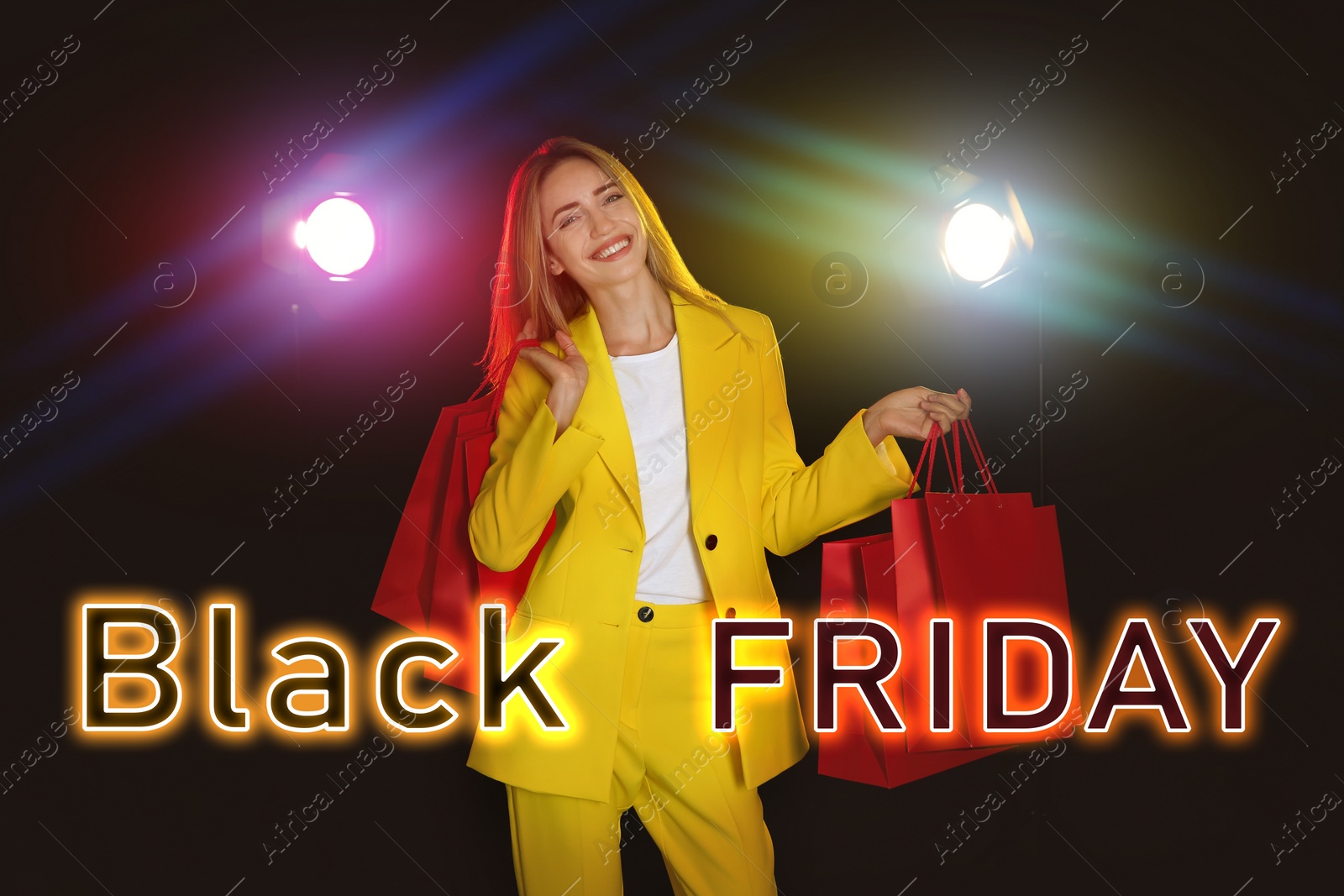 Image of Black Friday sale. Happy young woman with shopping bags 