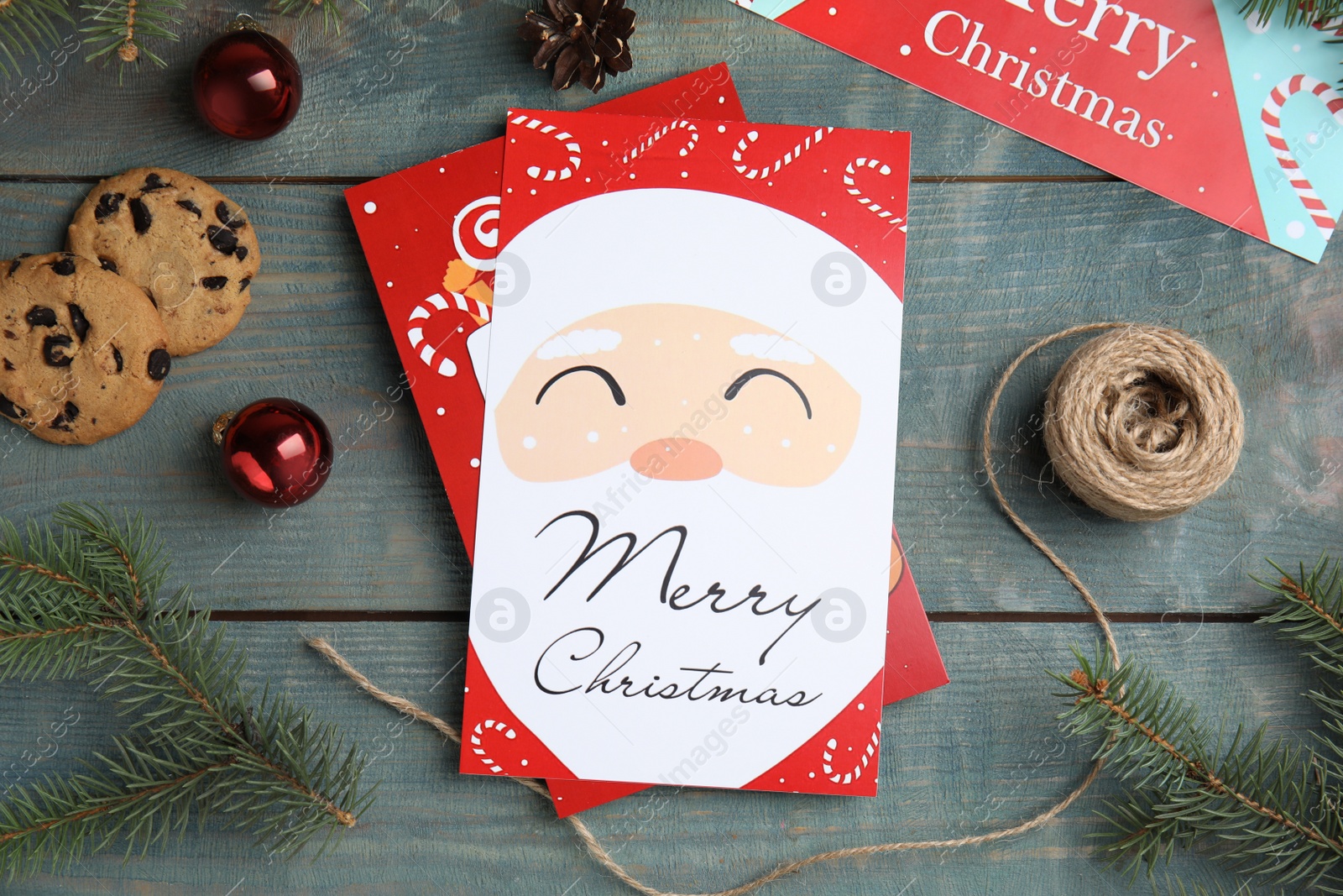 Photo of Flat lay composition with Christmas cards on light blue wooden background