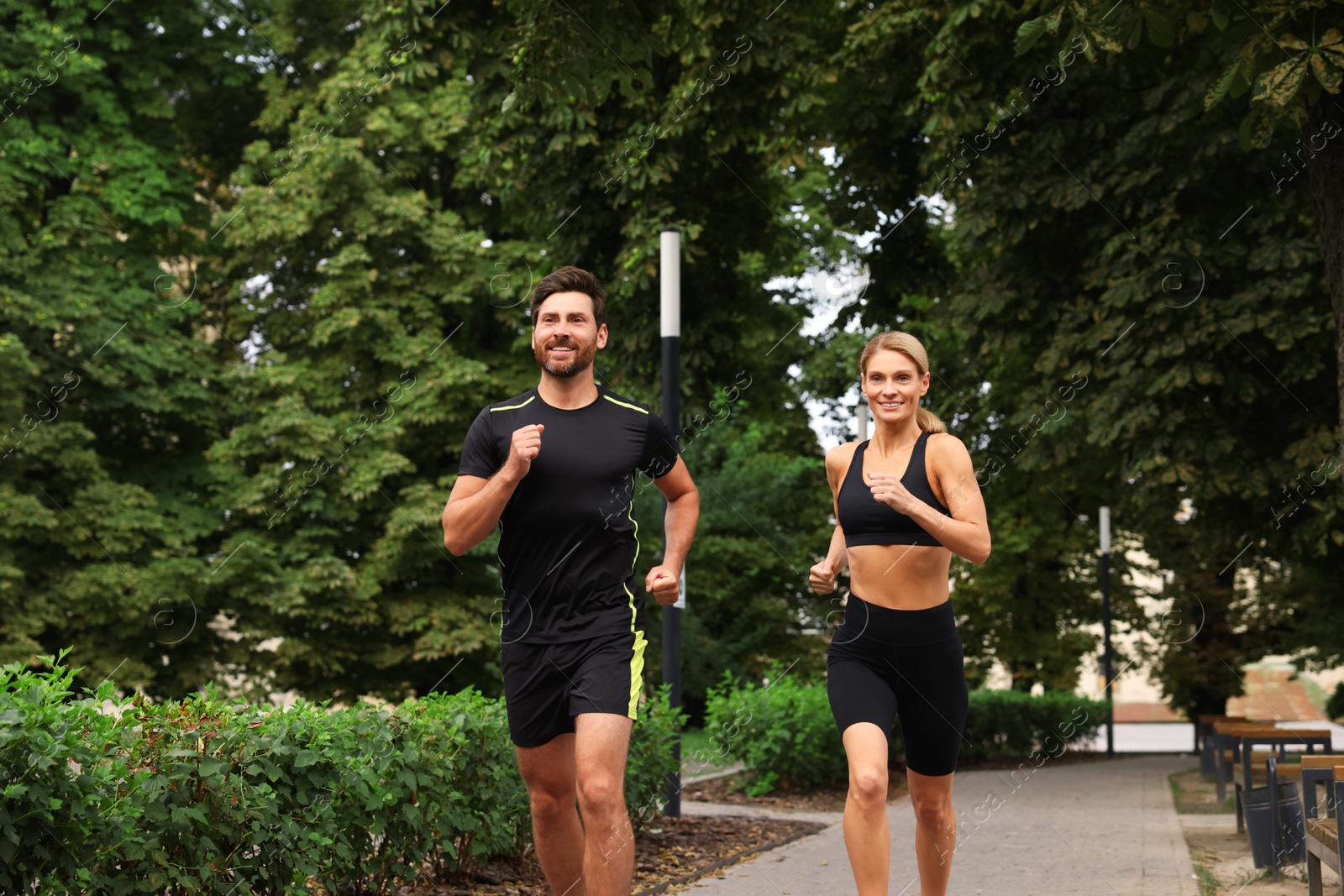 Photo of Healthy lifestyle. Happy couple running in park