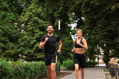 Healthy lifestyle. Happy couple running in park