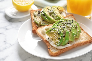 Photo of Toast bread with avocado and seeds on plate