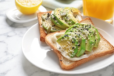 Toast bread with avocado and seeds on plate