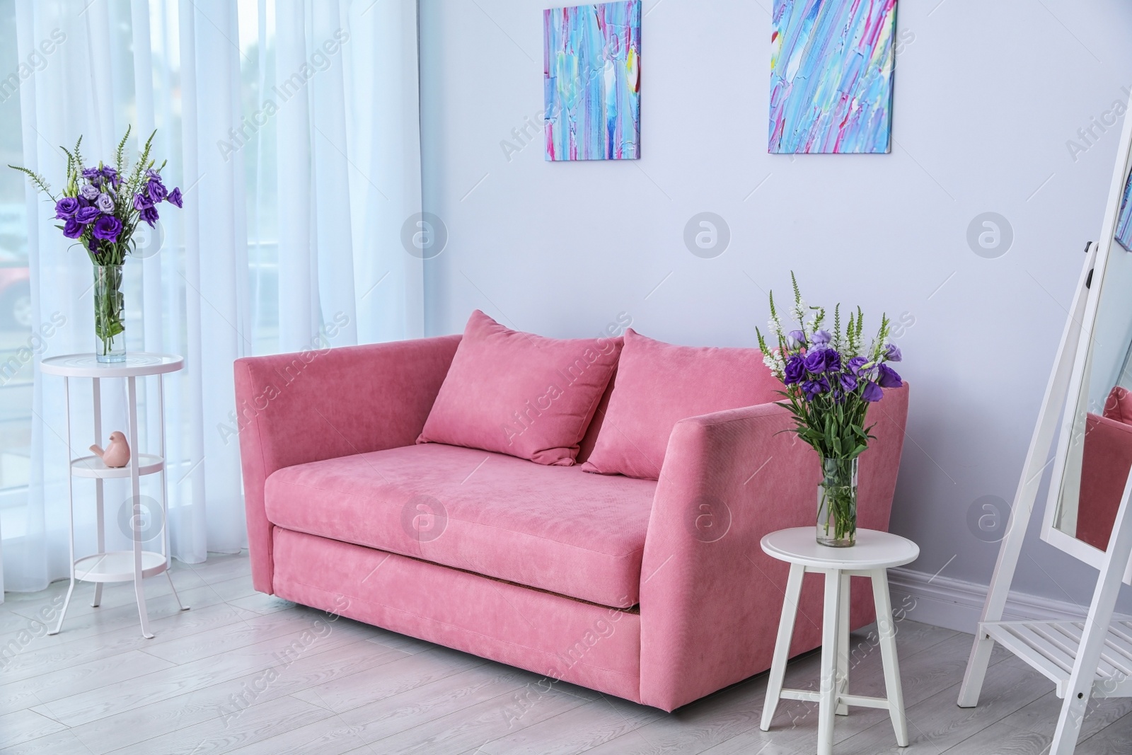 Photo of Modern interior of living room with comfortable sofa near white wall