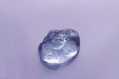 Photo of Sample of transparent shower gel on light background