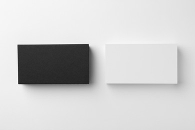 Photo of Blank business cards on white background, flat lay. Mockup for design