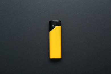 Photo of Stylish small pocket lighter on black background, top view