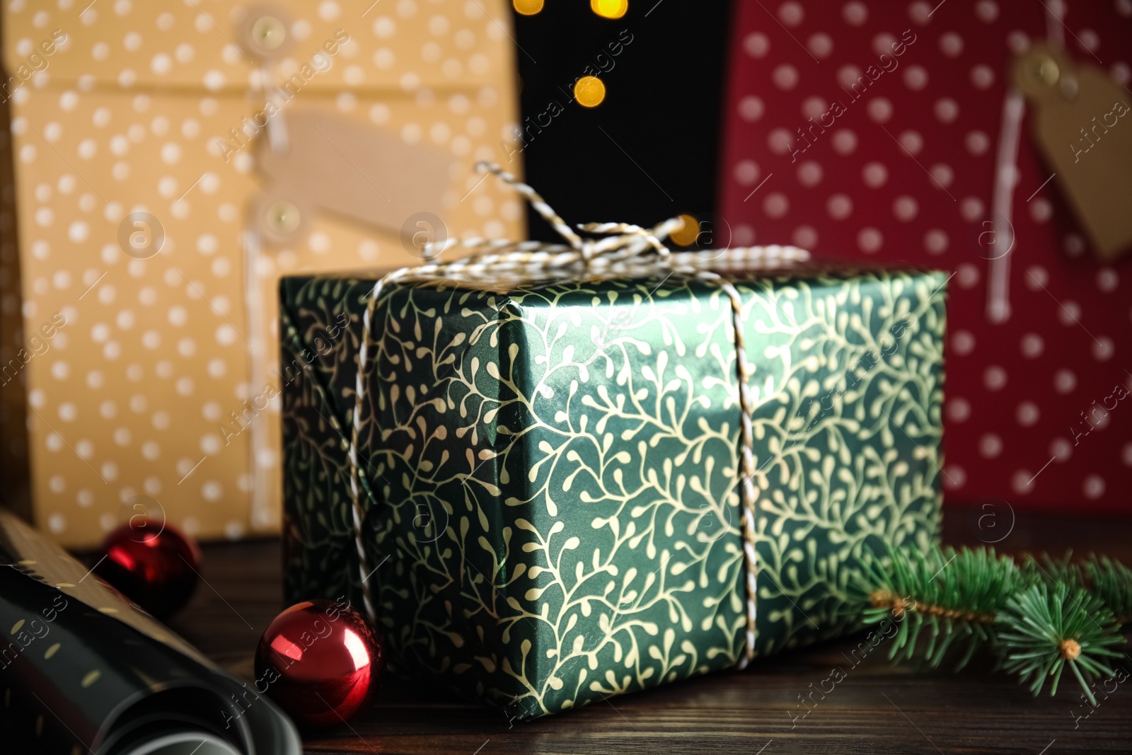 Photo of Composition with beautifully wrapped gift box on wooden table