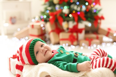 Cute baby in Christmas costume at home