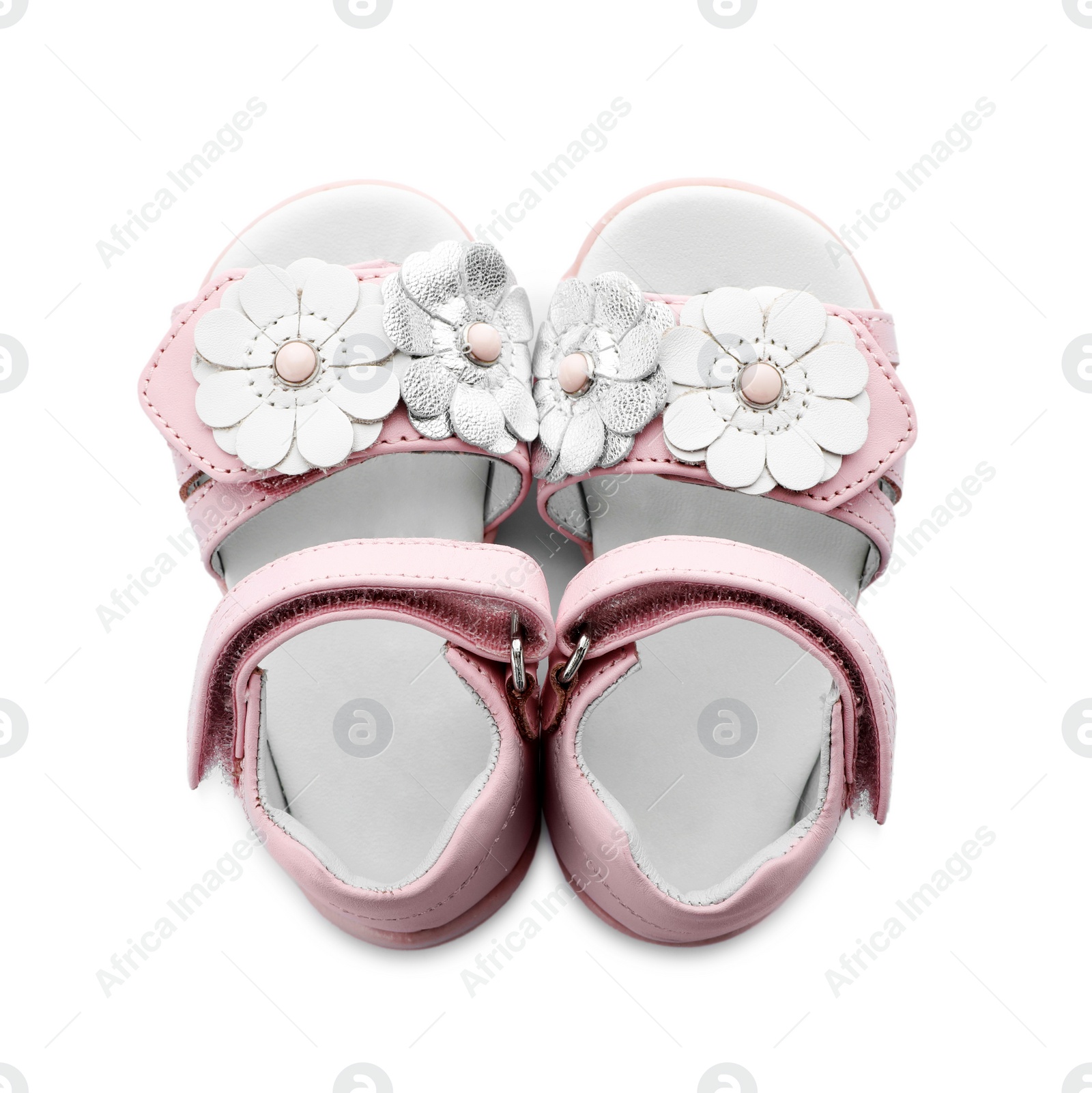 Photo of Pair of cute baby sandals decorated with flowers on white background, top view