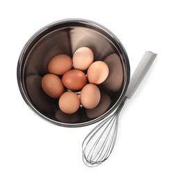 Metal whisk and raw eggs in bowl isolated on white, top view