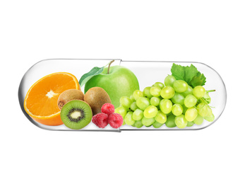 Transparent capsule with different fruits and berries rich in vitamins on white background